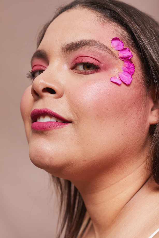 Curvy Woman with Bold Makeup and Flowers
