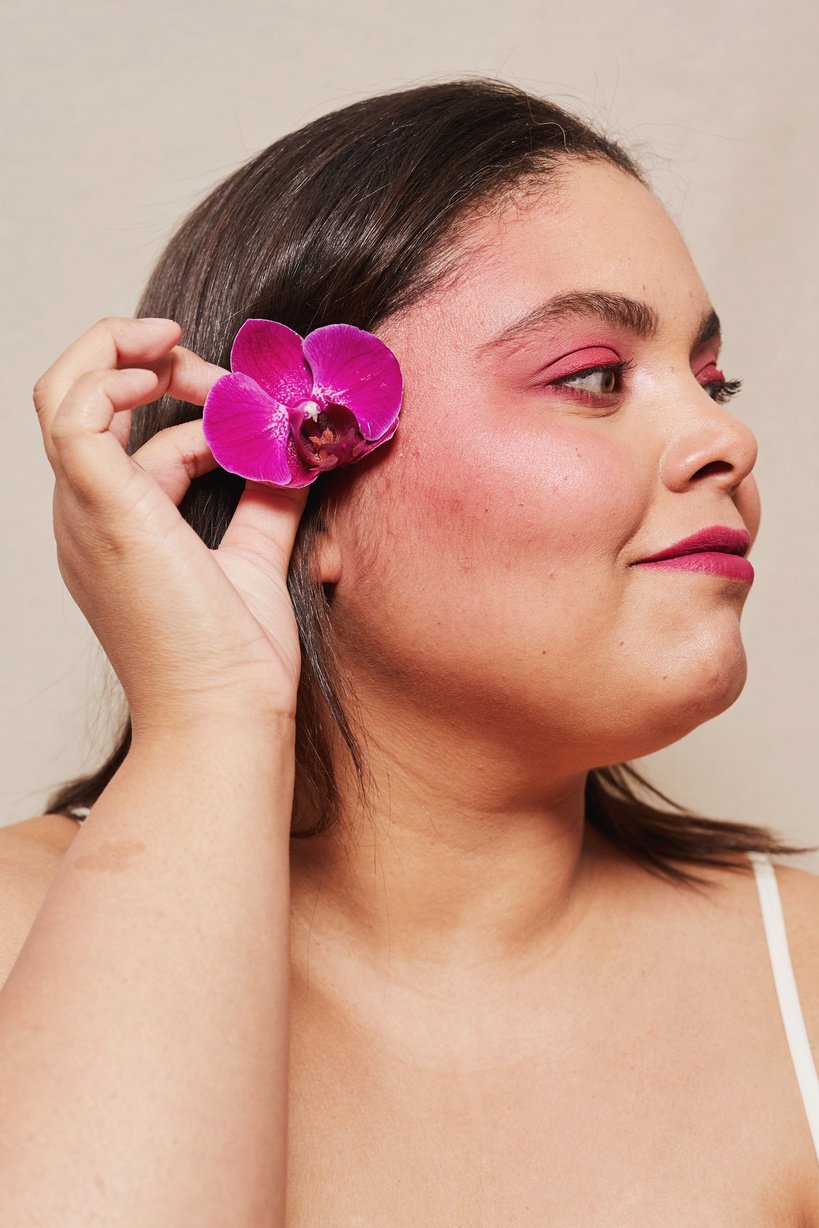 Curvy Woman with Bold Makeup and Flowers