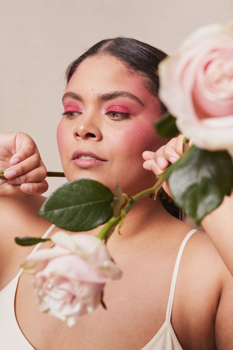Curvy Woman with Bold Makeup and Flowers