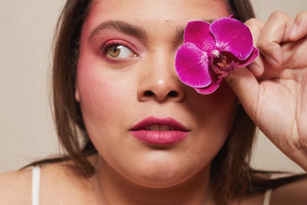 Curvy Woman with Bold Makeup and Flowers